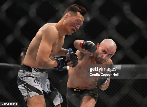 Alexander Volkanovski of Australia punches 'The Korean Zombie' Chan Sung Jung of South Korea in their UFC featherweight championship fight during the...