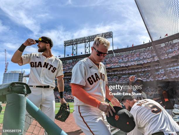 Steven Duggar and Joc Pederson of the San Francisco Giants walk into the dugout in between innings of their opening day game against the Miami...