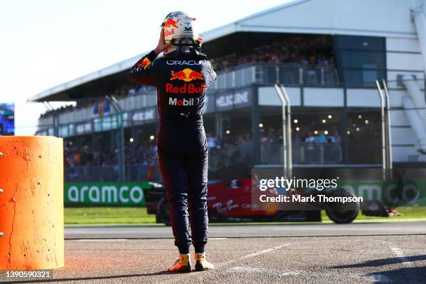 Max Verstappen of the Netherlands and Oracle Red Bull Racing looks on from the side of the track after retiring from the race as Charles Leclerc of...