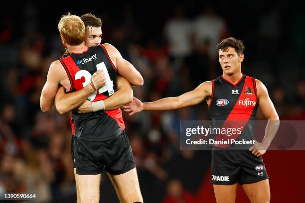 Sam Draper of the Bombers hugs Andrew Phillips of the Bombers after winning the round four AFL match between the Essendon Bombers and the Adelaide...