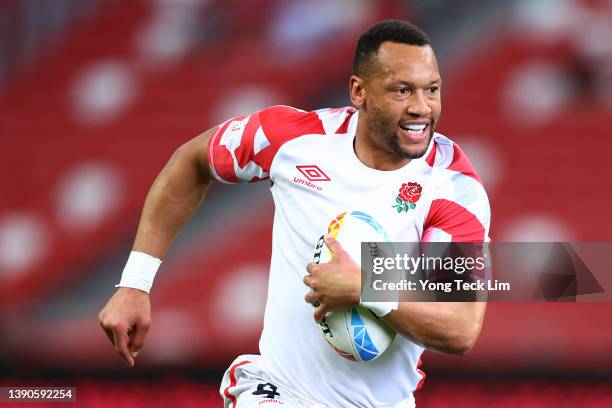 Dan Norton of England runs with the ball for a try against Canada in the first half of their 13th place semifinal match during the HSBC Singapore...