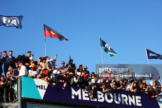 Fans watch the podium ceremony during the F1 Grand Prix of Australia at Melbourne Grand Prix Circuit on April 10, 2022 in Melbourne, Australia.