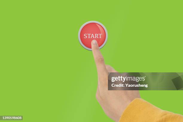 people hand pushing on the start button on green background - pressing the button cartoon stock pictures, royalty-free photos & images