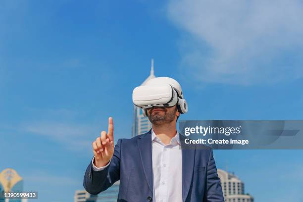 businessman wear virtual reality glasses technology for working business in urban outdoor. making business with technology concept background. - arab people stock pictures, royalty-free photos & images