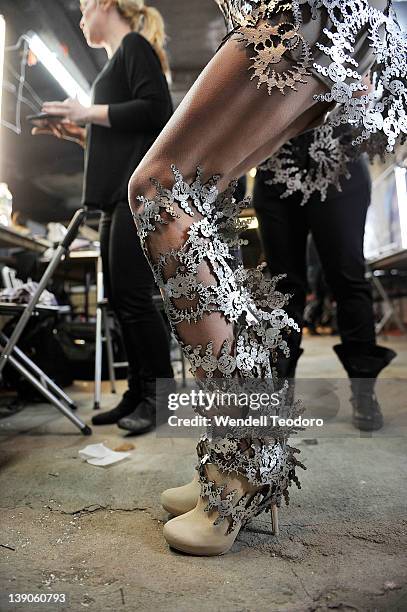 Model prepares backstage before the threeASFOUR Fall 2012 fashion show during Mercedes-Benz Fashion Week at the The Hole on February 15, 2012 in New...