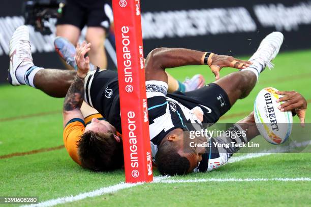 Elia Canakaivata of Fiji is tackled by Corey Toole of Australia before the try line in the second half of their cup semifinal match during the HSBC...