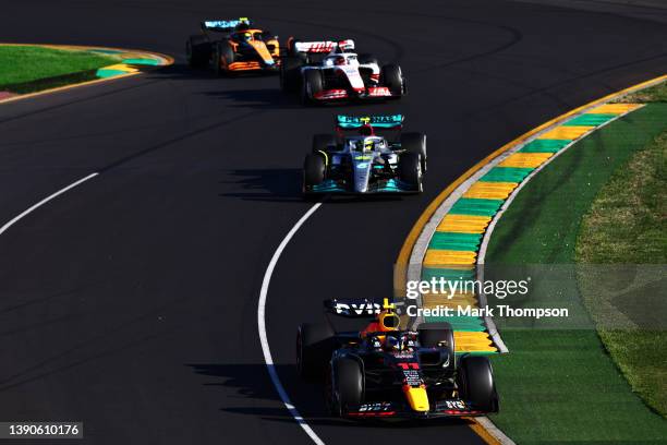 Sergio Perez of Mexico driving the Oracle Red Bull Racing RB18 leads Lewis Hamilton of Great Britain driving the Mercedes AMG Petronas F1 Team W13...