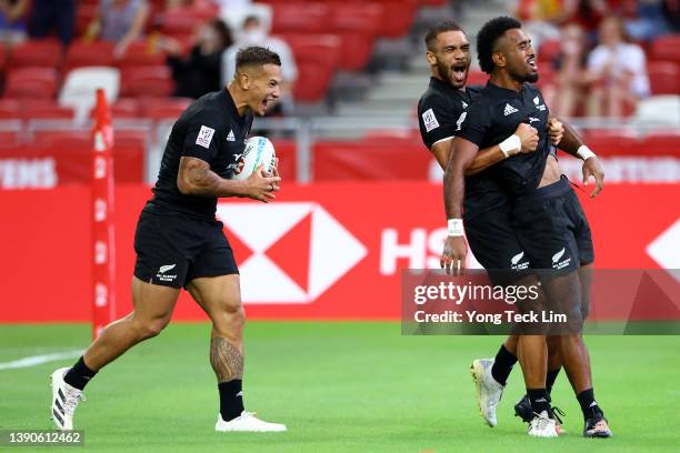 Akuila Rokolisoa of New Zealand celebrates with Trael Joass and Brady Rush after scoring the game-winning try against Ireland in the second half of...