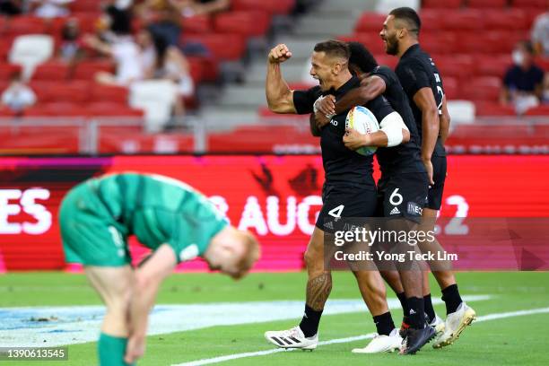 Akuila Rokolisoa of New Zealand celebrates with Trael Joass and Brady Rush after scoring the game-winning try against Ireland in the second half of...