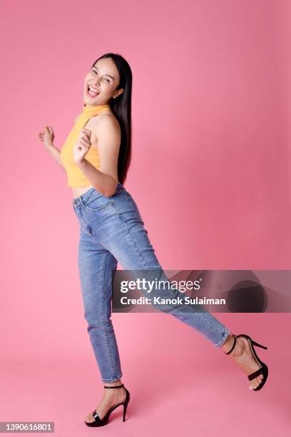 woman dancing - jumping casual clothing studio shot stock pictures, royalty-free photos & images