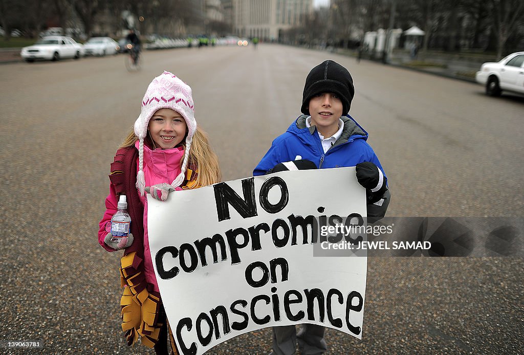 Two children hold a placard as they join