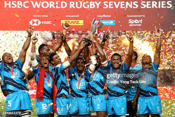The Fijian team celebrates with the winners' trophy after their cup final victory against New Zealand during the HSBC Singapore Rugby Sevens at the...