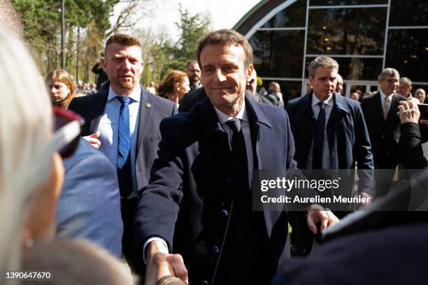 French President Emmanuel Macron salutes the crowd as he arrives to the poll station on April 10, 2022 in Le Touquet-Paris-Plage, France. Nearly 50...