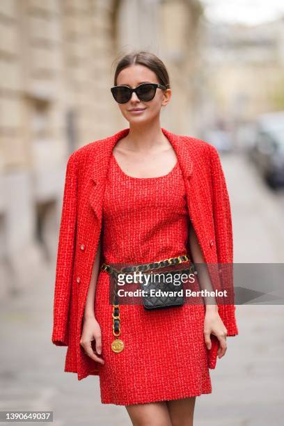 Diane Batoukina @diaanebt wears black sunglasses from Dior, a red tweed V-neck / tank-top short dress from Chanel, a matching red tweed long blazer...