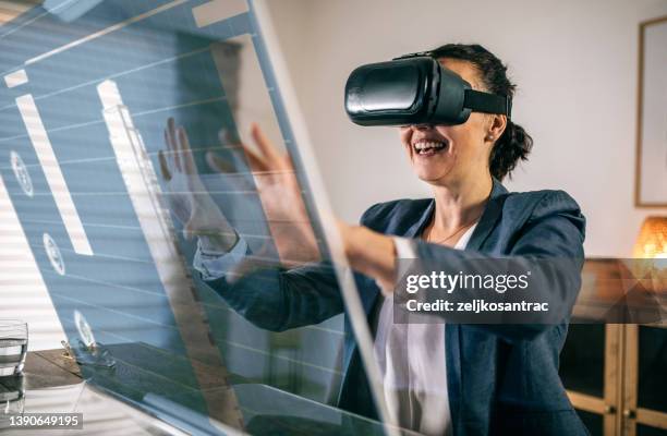businesswoman interacting with a virtual reality headset - digitalisering bildbanksfoton och bilder