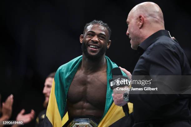 Aljamain Sterling talks with Joe Rogan after his UFC bantamweight championship fight against Petr Yan of Russia during the UFC 273 event at VyStar...