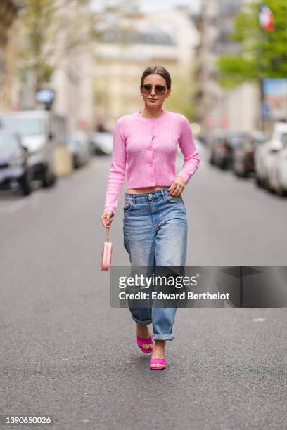 Diane Batoukina @diaanebt wears brown sunglasses from Dior, a pink wool buttoned cardigan from Mango, a silver Love ring from Cartier, blue faded...