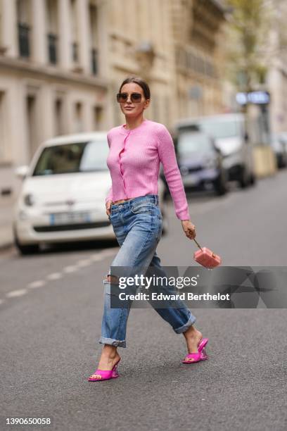 Diane Batoukina @diaanebt wears brown sunglasses from Dior, a pink wool buttoned cardigan from Mango, a silver Love ring from Cartier, blue faded...