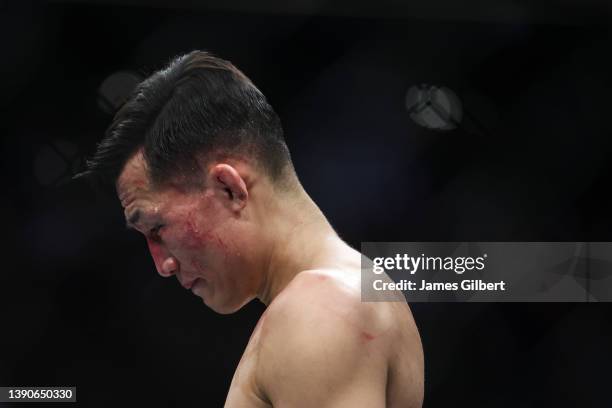 Chan Sung Jung of South Korea reacts after his TKO loss to Alexander Volkanovski of Australia in their UFC featherweight championship fight during...