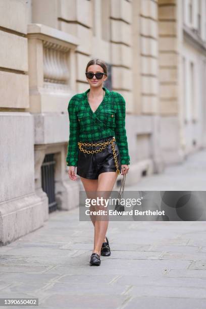 Diane Batoukina @diaanebt wears black sunglasses, a gold long chain necklace from Chanel, a black and green checkered print pattern tweed /...