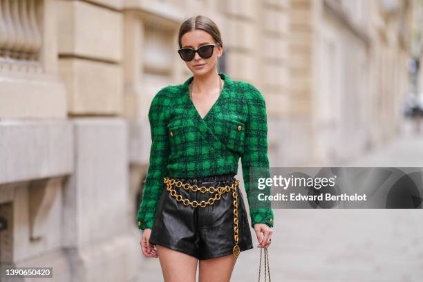 Diane Batoukina @diaanebt wears black sunglasses, a gold long chain necklace from Chanel, a black and green checkered print pattern tweed /...