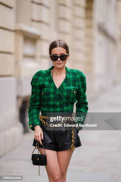 Diane Batoukina @diaanebt wears black sunglasses, a gold long chain necklace from Chanel, a black and green checkered print pattern tweed /...