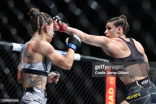 Mackenzie Dern punches Tecia Torres in their strawweight fight during the UFC 273 event at VyStar Veterans Memorial Arena on April 09, 2022 in...