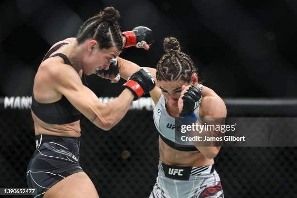 Tecia Torres punches Mackenzie Dern in their strawweight fight during the UFC 273 event at VyStar Veterans Memorial Arena on April 09, 2022 in...