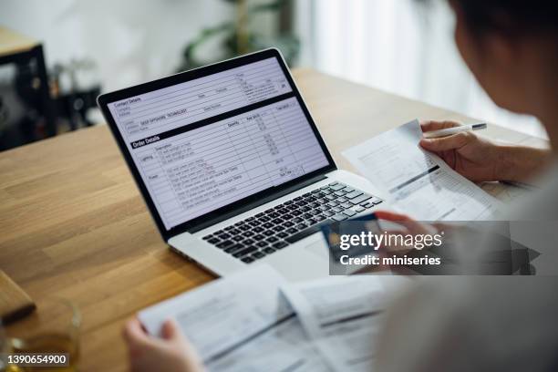 unrecognizable couple paying bills at home - electricity bill stock pictures, royalty-free photos & images