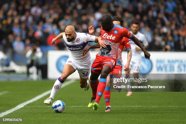 Sofyan Amrabat of Fiorentina battles for possession with Kalidou Koulibaly of SSC Napoli during the Serie A match between SSC Napoli and ACF...