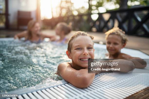 family enjoying outdoors hot tub hot tub in the back yard - family wealth stock pictures, royalty-free photos & images