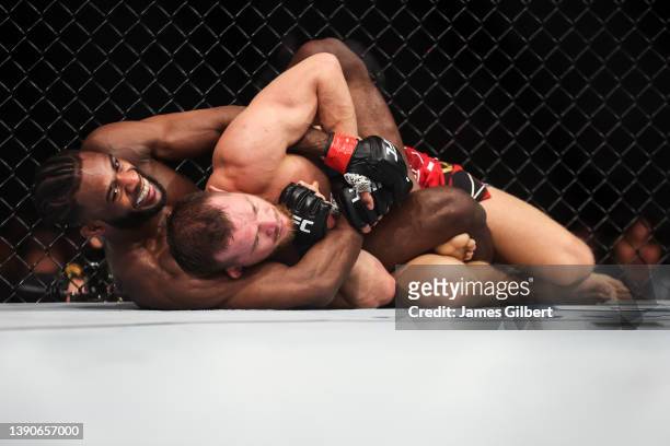 Aljamain Sterling grapples Petr Yan of Russia during their UFC bantamweight championship fight during the UFC 273 event at VyStar Veterans Memorial...