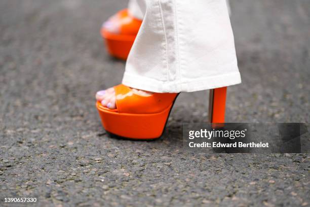 Maria Rosaria Rizzo @lacoquetteitalienne wears high waist with silver buttoned / white latte denim / flared pants, neon orange shiny leather platform...