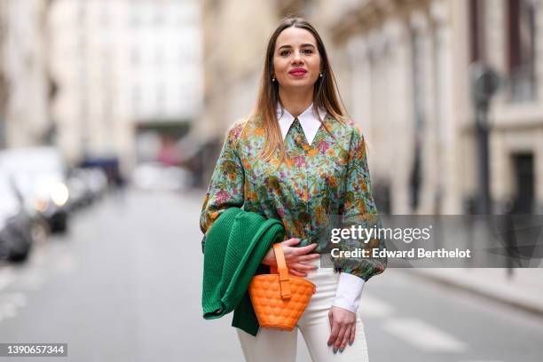 Maria Rosaria Rizzo @lacoquetteitalienne wears white pearl earrings, a pale blue with green / orange / purple flower print pattern shirt, high waist...