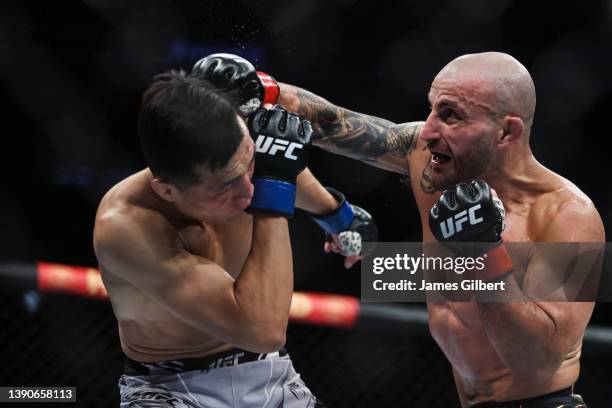 Alexander Volkanovski of Australia punches Chan Sung Jung of South Korea in their featherweight title fight during the UFC 273 event at VyStar...
