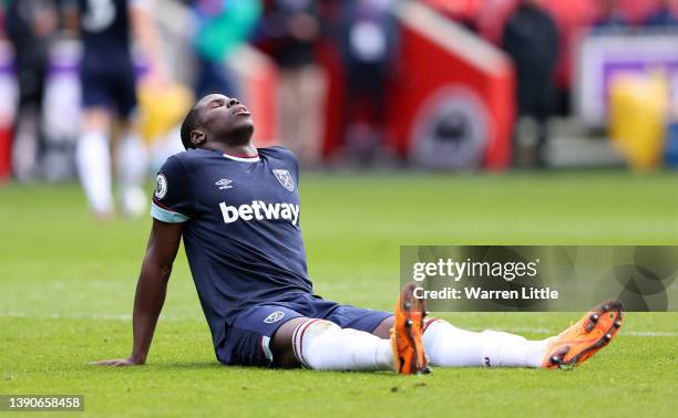 Kurt Zouma of West Ham United reacts as he appears to be injured during the Premier League match between Brentford and West Ham United at Brentford...