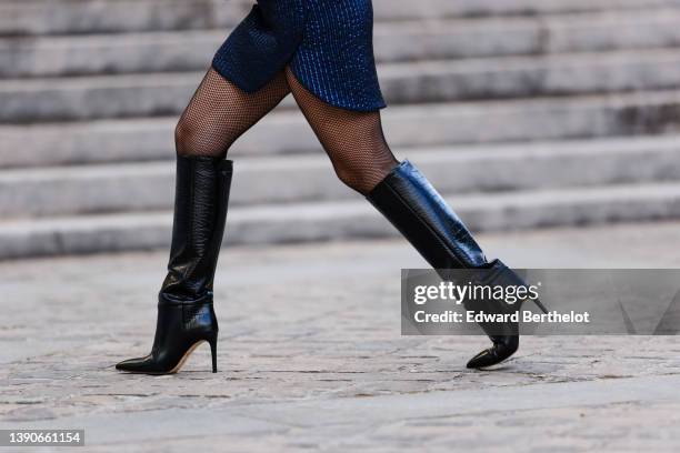 Maria Rosaria Rizzo @lacoquetteitalienne wears a navy blue and blue silver striped print pattern asymmetric short skirt, black fishnet tights, gold...