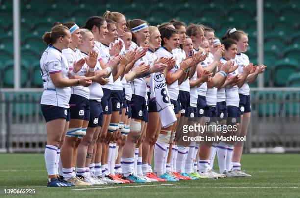 Scottish players take part in a minutes applause for former British Lion Tom Smith during the Scotland and France Women's Six Nations match at...