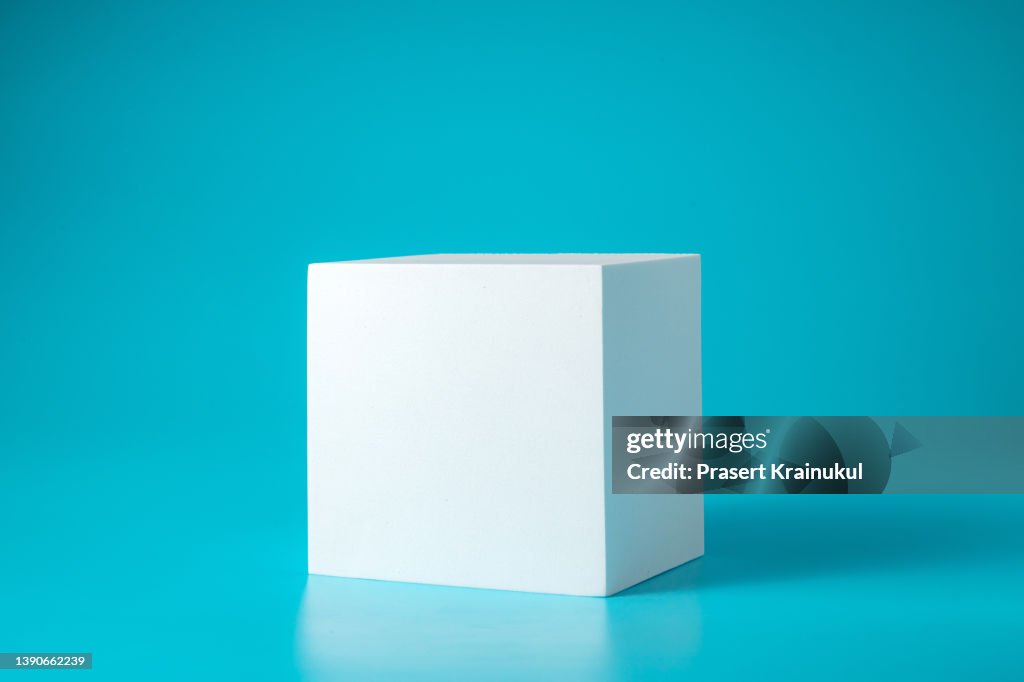 Geometry shaped podium for mock up presentation in gray color and minimalist style with copy space