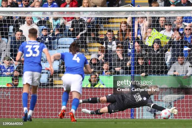 Kasper Schmeichel of Leicester City makes a save from a penalty kick took by Wilfried Zaha of Crystal Palace during the Premier League match between...