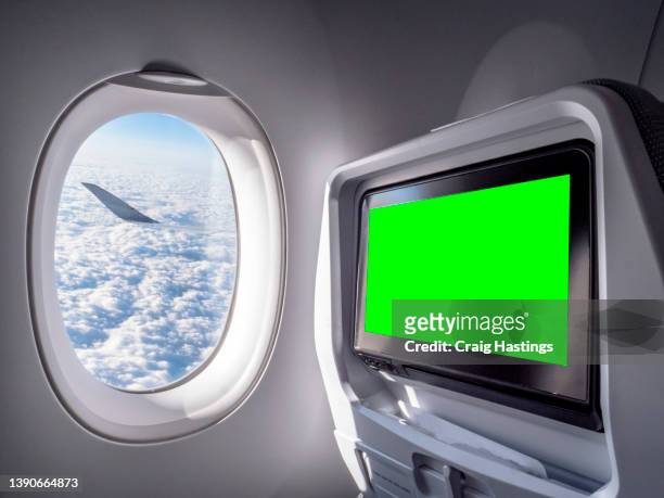 medium size green screen chroma key marketing advertisement billboard on board long haul large airplane back of seat in flight entertainment system or airport environment targeting adverts at consumers, flight shoppers, commuters, passenger and tourists - window display stock-fotos und bilder