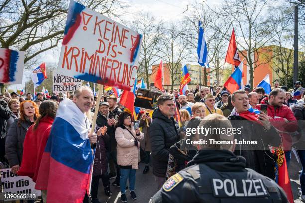 People gather to show their support for Russia at a demonstration that was taking place under the motto "Against Baiting And Discrimination of...