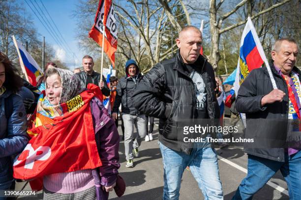 Man wears a shirt with the face of Wladimir Putin while he demonstrates with others to show their support for Russia at a demonstration that was...