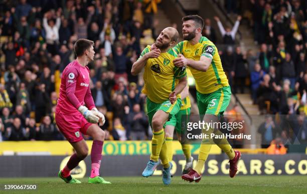 Teemu Pukki of Norwich City celebrates with team mate Grant Hanley after scoring their sides second goal during the Premier League match between...