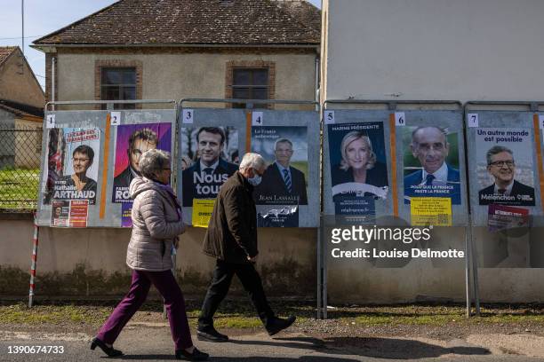 Voters walk outside a polling station on April 10, 2022 in Champigny, Yonne, France. Nearly 50 million French people will be called to the polls in...