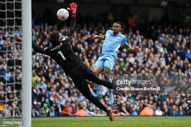 Gabriel Jesus of Manchester City scores their side's second goal past Alisson Becker of Liverpool during the Premier League match between Manchester...