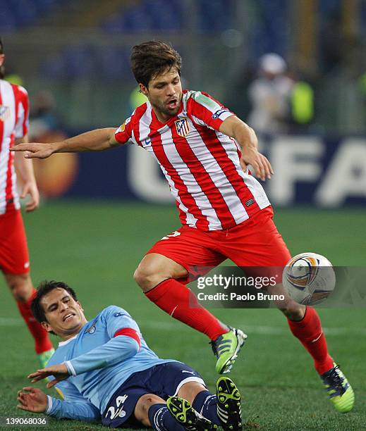 Diego of Club Atletico de Madrid competes for the ball with Cristian Ledesma of SS Lazio during the UEFA Europa League Round of 32 match between S.S....