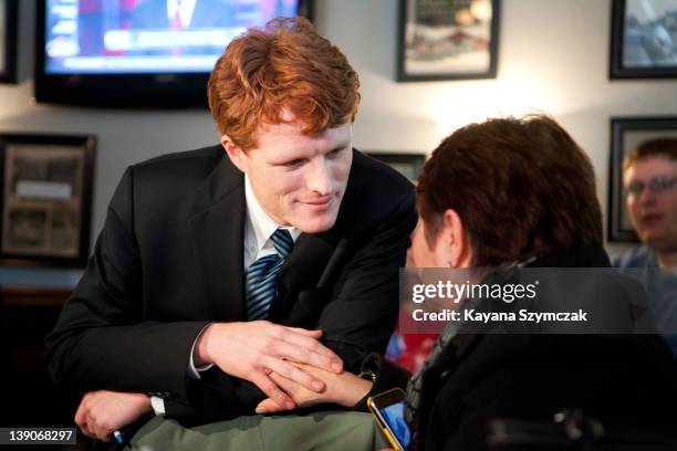 Joseph Kennedy III talks with a person while visiting Morin's Hometown Bar and Grille on February 16, 2012 in Attleboro, Massachusetts. Kennedy...