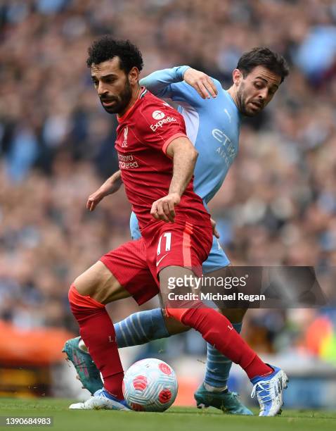 Mohamed Salah of Liverpool is challenged by Bernardo Silva of Manchester City during the Premier League match between Manchester City and Liverpool...