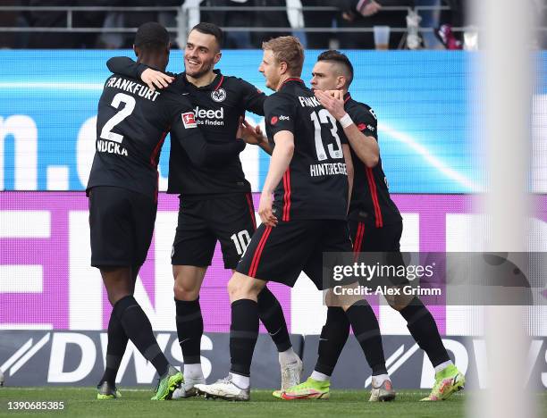 Filip Kostic of Eintracht Frankfurt celebrates after scoring their side's first goal with Evan Ndicka and Martin Hinteregger during the Bundesliga...